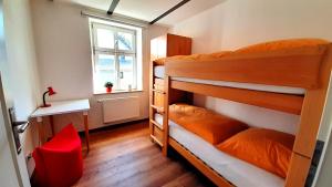 a bedroom with two bunk beds and a window at Ferienwohnungen Zur Tenne in Beckingen