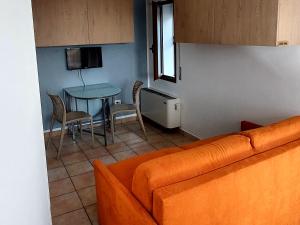 a living room with a couch and a table at Villa Augusta in Auronzo di Cadore