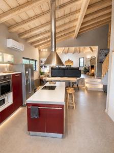 a kitchen with red cabinets and a table in a room at Le Blanc in Dassia