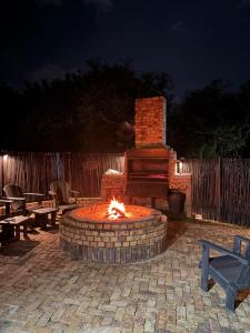 a fire pit in a patio at night at Inyathi Inn in Marloth Park