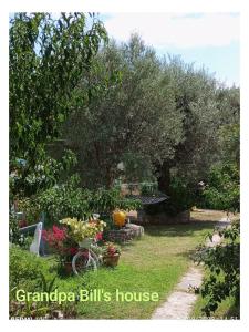 a garden with a bike parked in the grass at Grandpa BILL's house 6 in Pyrgadikia