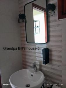 a bathroom with a sink and a mirror at Grandpa BILL's house 6 in Pyrgadikia +12 photos