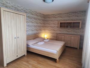a small bedroom with a bed and a cabinet at Gloria in Olomouc