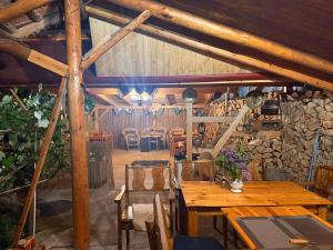 a dining room with wooden tables and chairs at Casa Cosmin in Dobra