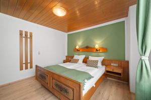 a bedroom with a bed and a wooden ceiling at Ferienhaus Seehang in Meersburg