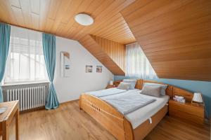 a bedroom with a bed and a wooden ceiling at Ferienhaus Seehang in Meersburg