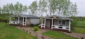 two small houses sitting in a yard with a yard at Domek ASIA in Wronka
