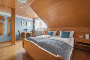 a bedroom with a large bed with a wooden headboard at Ferienhaus Seehang in Meersburg +45 photos