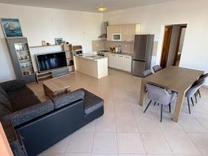 a living room with a couch and a table and a kitchen at Lana&Ema in Kali