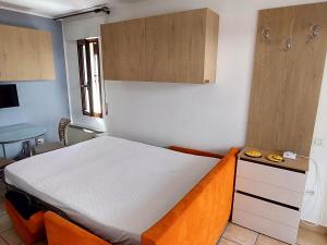 a small bedroom with a bed and a desk at Villa Augusta in Auronzo di Cadore +27 photos