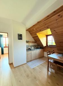 a kitchen with a table and a dining room at Pod Kasztanami in Międzylesie