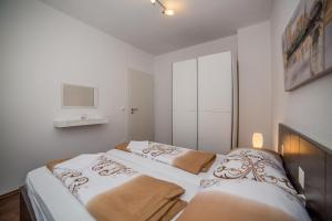Posteľ alebo postele v izbe v ubytovaní Apartments Kati