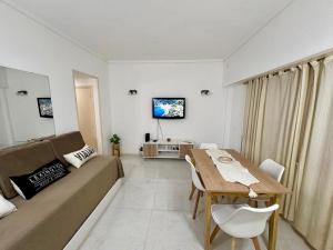 a living room with a couch and a table at Alsina Mdq in Mar del Plata