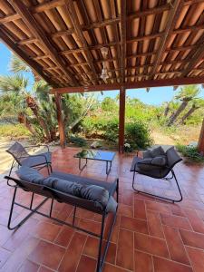 a patio with two lounge chairs and a table at CasAmare in Pizzolungo +36 photos