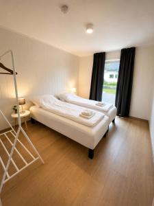 a room with two beds and a ladder in it at Reine Sea Apartment in Moskenes