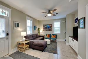 a living room with a couch and a tv at Bungalows at Seagrove #142 in Seagrove Beach
