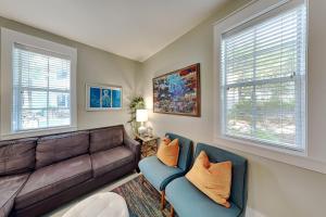 a living room with a couch and two chairs at Bungalows at Seagrove #142 in Seagrove Beach