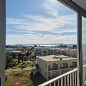 a view of a building from a balcony at Appartement neuf full équipe in Palavas-les-Flots