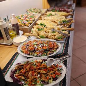a buffet line of plates of food on a table at Willa u Zwijaczy in Zakopane