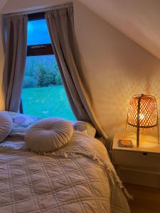a bedroom with a bed and a window at Cosy nap under the Paps in Killarney