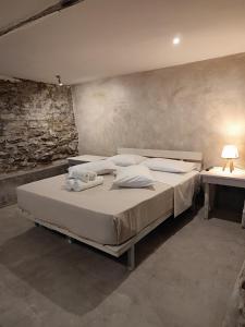 a bedroom with a large bed and a table at Kamara 1898 katoi in Mouresi