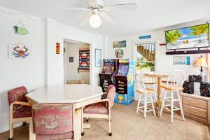 a dining room with a table and chairs at 6170 - Poolside Paradise in Nags Head