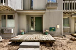 a house with a green door and two potted plants at Sanctuary at Sundendorf- New Updates! in Bellaire