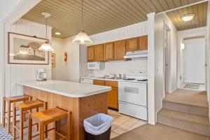 a kitchen with wooden cabinets and a white counter top at Sanctuary at Sundendorf- New Updates! in Bellaire +29 photos