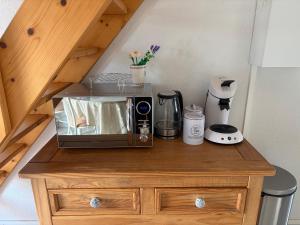 a microwave sitting on top of a wooden cabinet at 225 rue de la source in Bretignolles-sur-Mer