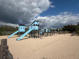 a row of playground equipment on a beach at 225 rue de la source in Bretignolles-sur-Mer