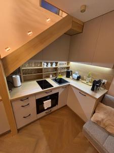 a kitchen with a sink and a stove top oven at Apartament Ana in Lublin +9 photos