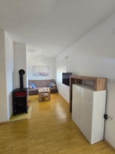 a living room with a couch and a stove at Apartment Loza Senj in Senj