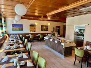 a restaurant with wooden ceilings and tables and chairs at Pension Weber in Vienna