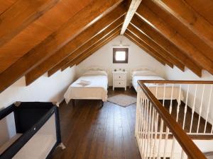 a attic room with two beds and a staircase at La casa de Rodrigo y Manuela in Tarifa