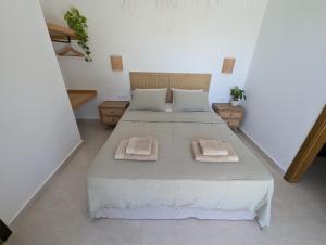 a bedroom with a bed with two towels on it at Guesthouse Morito in Ierissos