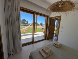 a bedroom with a bed and a large window at Guesthouse Morito in Ierissos +26 photos