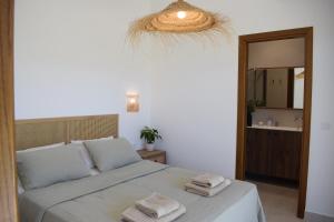 a bedroom with a bed with two towels on it at Guesthouse Morito in Ierissos