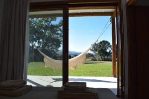 a hammock outside a window with a view of a yard at Guesthouse Morito in Ierissos