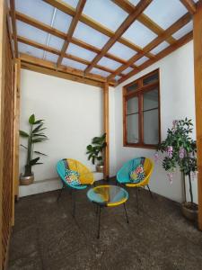 three chairs and two tables on a patio at Casa Marina Sotomayor in Santiago