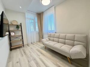 a living room with a couch and a book shelf at Home sweet home 2 in Chişinău
