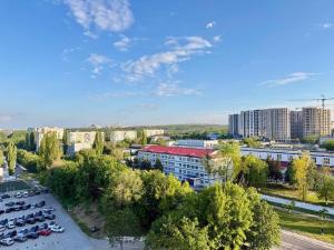 a city with cars parked in a parking lot at Home sweet home 2 in Chişinău