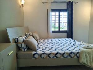 a bedroom with a bed and a window at Villa Bamba TERANGA in Somone +19 photos