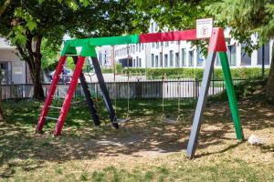 a playground with a swing set in a park at Gästehaus am Wasserpark in Rust