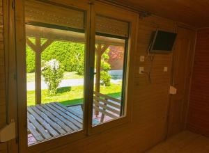 a room with a window and a view of a porch at Apartmány Harmónia in Veľký Meder