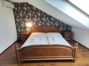 a bedroom with a wooden bed in a attic at Gloria in Olomouc +12 photos