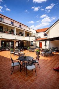 a courtyard with tables and chairs in a building at Hotel Sebastian u Hoffera in Modra