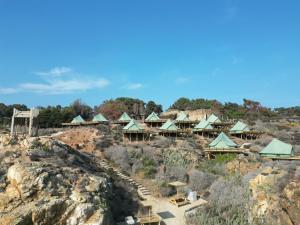 a resort on top of a rocky hill at La Ballenera Lodge in Guaquen