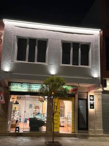 a store front of a building at night at Logan Rooms Berat in Berat