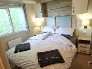 a bedroom with a large bed with two bags on it at The Cosy Nook in Launceston