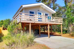 a house on a wooden structure with a balcony at 5041 - The Captains Quarters in Kill Devil Hills +16 photos
